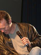 Anthony Head on a chair on stage