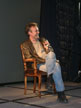 Anthony Head on a chair on stage