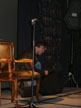 Anthony Head on a chair on stage