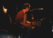 Tony on stage with guitar (red shirt)
