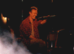 Tony on stage with guitar (red shirt)